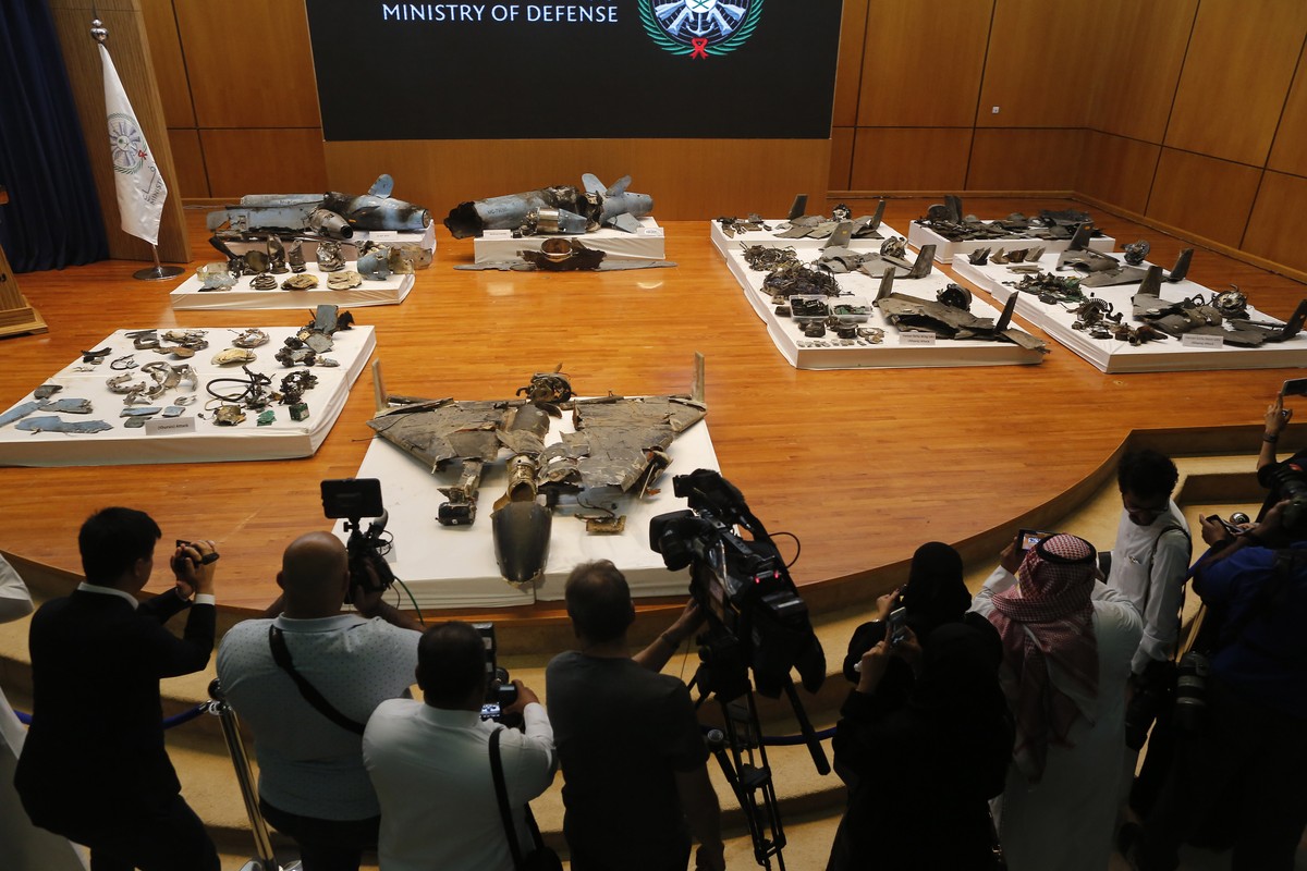 Journalists film what Saudi military spokesman Col. Turki al-Malki said was evidence of Iranian weaponry used in the attack targeted Saudi Aramco's facilities in Abqaiq and Khurais, during a pres ...