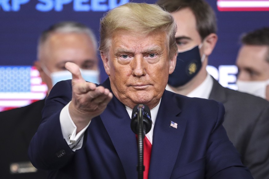 epa08871207 US President Donald J. Trump gestures during his speech during an Operation Warp Speed Vaccine Summit in the South Court Auditorium of the of the Eisenhower Executive Office Building at th ...