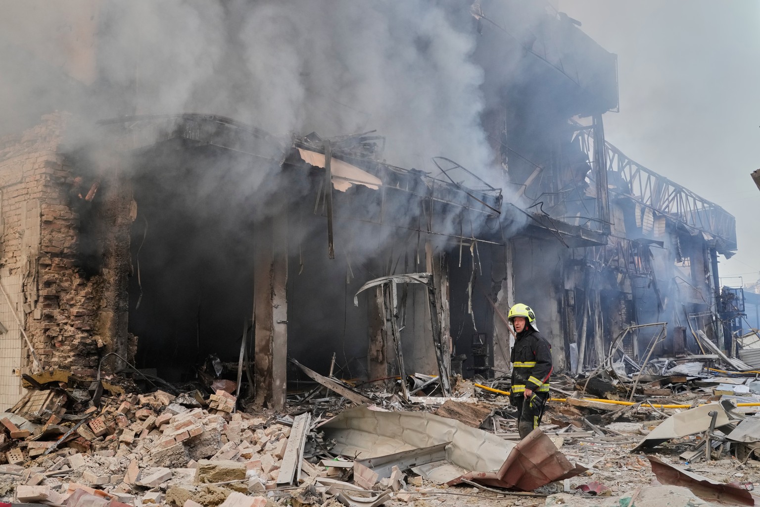 A firefighter puts out the fire at a city marketplace that was hit by Russian missiles during air attack on capital Kyiv, Ukraine, Sunday, May 24, 2026. (AP Photo/Efrem Lukatsky)
Russia Ukraine War