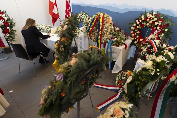 European Parliament President Roberta Metsola signs a condolence book prior to the official commemorative ceremony and the national day of mourning following the deadly fire at the "Le Constellat ...