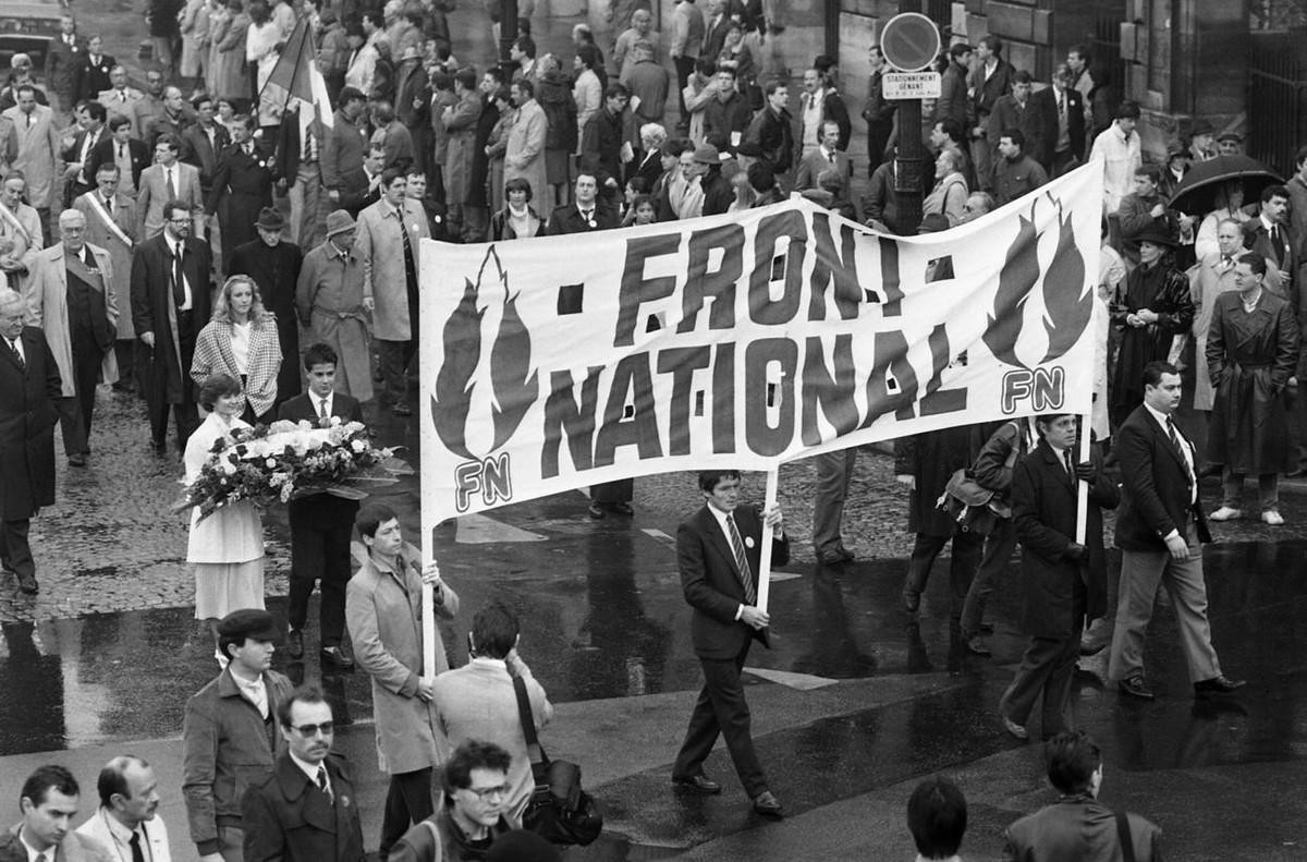 Leader of the French National Front Jean Marie Le Pen leads a march to the statue of Joan of Arc with his daughter Marine Le Pen on May 12, 1985. (AP Photo/Herve Merliac)