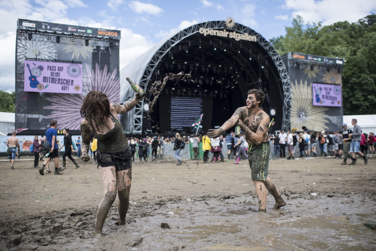 Visitors play in a puddle during the music festival Openair St. Gallen, on Saturday, July 1, 2017. The festival will take place until Sunday, July 2, 2017. (KEYSTONE/Ennio Leanza)