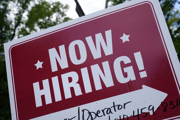 A &quot;now hiring&quot; sign is posted in Garnet Valley, Pa., Monday, May 10, 2021. Applications for unemployment benefits inched down last week, Thursday, April 21, 2022, as the total number of Amer ...