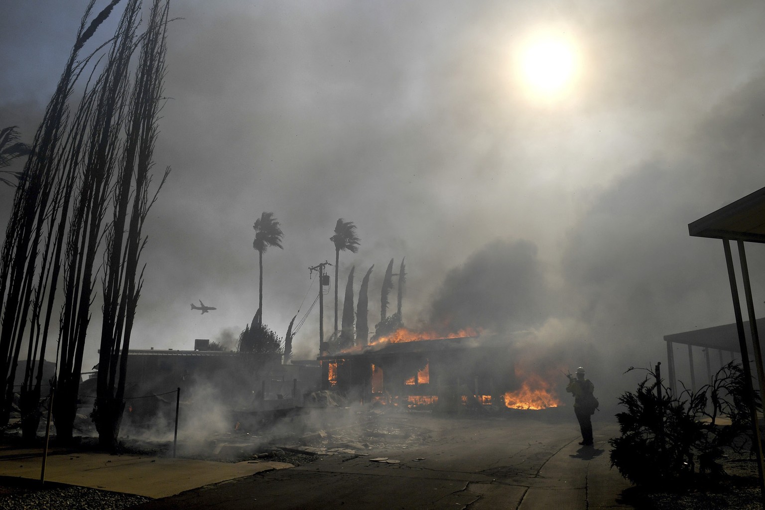 Firefighters battle the Sandalwood Fire as it destroys homes in the Villa Calimesa Mobile Home Park in Calimesa, Calif., on Thursday, Oct. 10, 2019. Burning trash dumped along a road sparked a wildfir ...