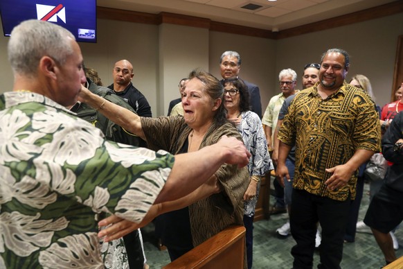 Albert &quot;Ian&quot; Schweitzer, left, hugs his mother, Linda, moments after a judge ordered him released from prison, in Hilo, Hawaii, Tuesday, Jan. 24, 2023. The judge&#039;s ruling came immediate ...