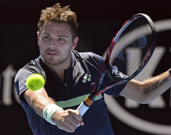Switzerland&#039;s Stan Wawrinka makes a backhand return to Lithuania&#039;s Ricardas Berankis during their first round match at the Australian Open tennis championships in Melbourne, Australia, Tuesd ...