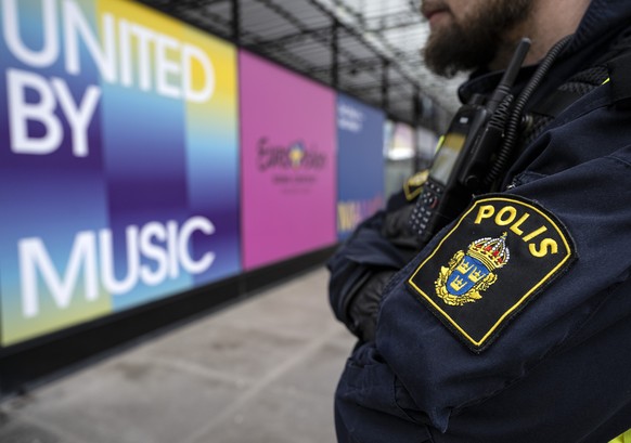 epa11302596 A police officer stands outside Malmo Arena, in Malmo, Sweden, 26 April 2024. Police and bomb dogs were on site at the Malmo Arena and at several of the hotels in the city as part of the o ...