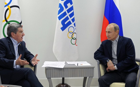 FILE - In this Feb. 15, 2014 file photo Russian President Vladimir Putin, right, and IOC President Thomas Bach meet in the Bolshoi Ice Dome in Sochi, Russia. A year out from the Paris Olympics, and ne ...