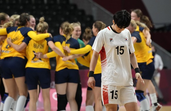 South Korea&#039;s Sumin Choi reacts disappointed as Sweden players celebrate as they won the women&#039;s quarterfinal handball match between Sweden and South Korea at the 2020 Summer Olympics, Wedne ...