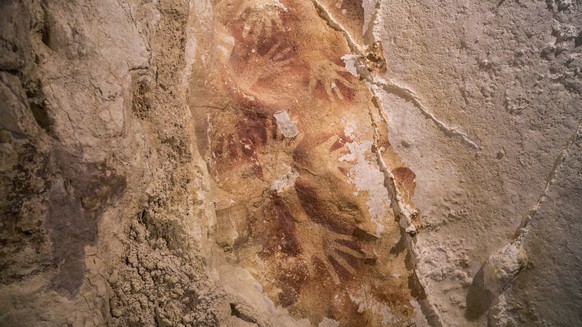 This undated handout photo provided by Nature Magazine shows stencils of hands in a cave in Indonesia. Ancient cave drawings in Indonesia are as old as famous prehistoric art in Europe, according to a ...