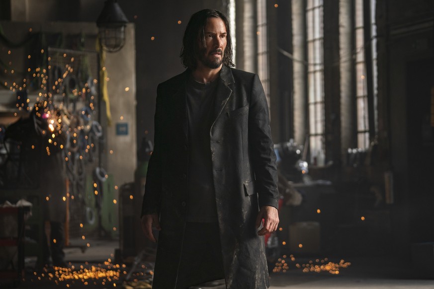 This image released by Warner Bros. Pictures shows Keanu Reeves in a scene from &quot;The Matrix Resurrections.&quot; (Warner Bros. Pictures via AP)