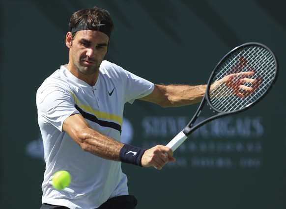 Roger Federer returns a shot to Filip Krajinovic during the third round of the BNP Paribas Open tennis tournament at the Indian Wells Tennis Garden in Indian Wells, Calif., Monday, March 12, 2018. (AP ...