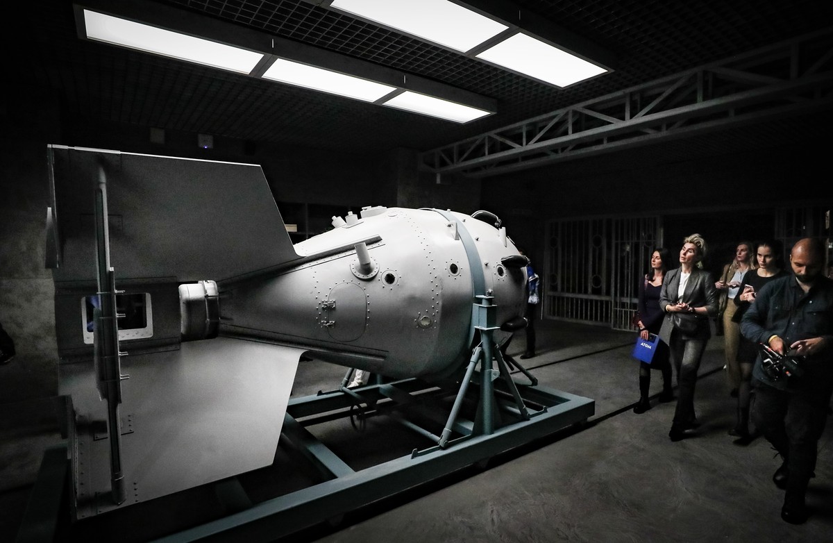 epa10940875 Visitors look at scale model of the casing for the first Soviet atomic bomb 'RDS-1' during a press tour of the new 'Atom' pavilion dedicated to Rosatom corporation at t ...