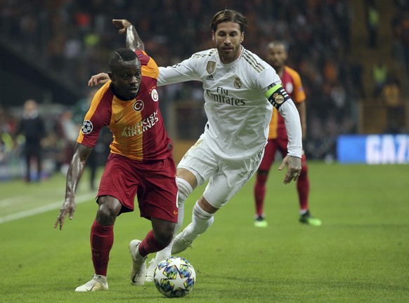 Galatasaray&#039;s Jean Michael Seri, left, duels for the ball with Real Madrid&#039;s Sergio Ramos during the Champions League group A soccer match between Galatasaray and Real Madrid in Istanbul, Tu ...