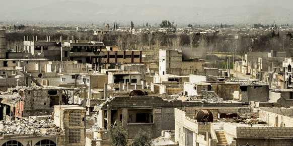 epa06583430 A handout photo made available on 05 March 2018 by Syrian Arab news agency SANA shows the damaged buildings in Al-Nashabieh town in Eastern Ghouta Damascus countryside Syria, after liberat ...