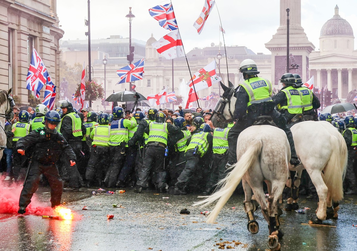 epa12374436 Flares are thrown as protesters taking part in a 'Unite the Kingdom' rally are held back by police officers, in central London, Britain, 13 September 2025. Two opposing demonstra ...