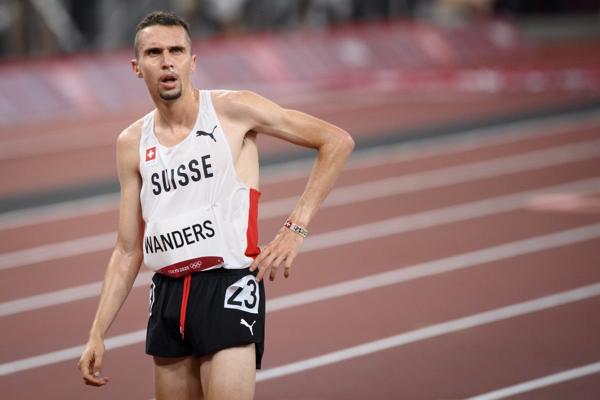 epa09379908 Julien Wanders of Switzerland reacts after crossing the finish line of the men's 10,000m final during the Athletics events of the Tokyo 2020 Olympic Games at the Olympic Stadium in To ...