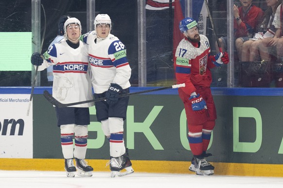 epa12993017 Norway's Petter Vesterheim, left, and Norway's Nichael Brandsegg-Nygard celebrate the 0-2 goal next to Czechia's Filip Hronek during the 2026 IIHF Men's Ice Hockey Worl ...