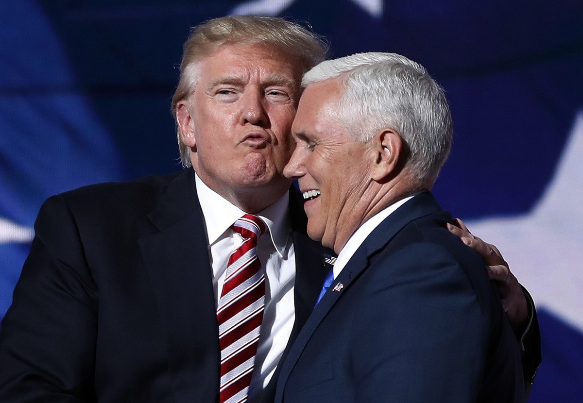 2016 AP YEAR END PHOTOS - Republican presidential Candidate Donald Trump gives his running mate, Gov. Mike Pence of Indiana, a kiss as they shake hands after Pence's acceptance speech to be the v ...