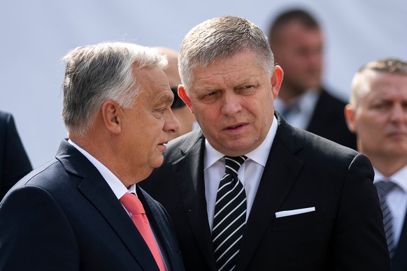 Hungary&#039;s Prime Minister Viktor Orban, left, and his Slovakian counterpart Robert Fico talk to each other before delivering their speeches during the 130th anniversary celebration of Mária Valeri ...