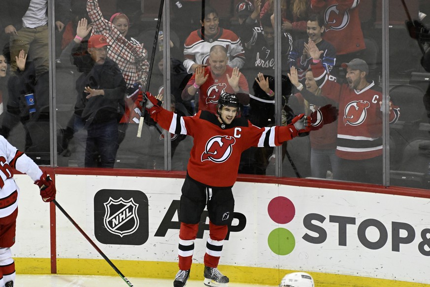 FILE - New Jersey Devils center Nico Hischier (13) celebrates his goal during the third period of an NHL hockey game against the Carolina Hurricanes, Saturday, April 23, 2022, in Newark, N.J. Coming i ...