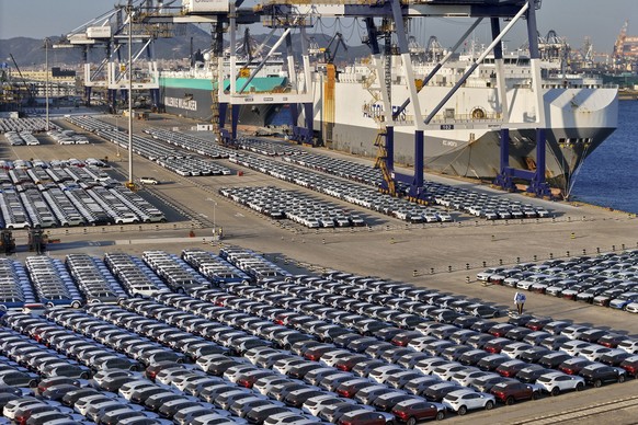 FILE - New cars for export wait for transportation on a vehicles carrier vessel at a dockyard in Yantai in east China&#039;s Shandong province on Nov. 2, 2023. Chinese auto sales slumped in June, 2024 ...