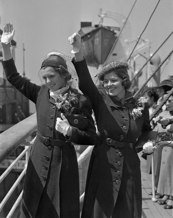 Eunice and Rosemary (l to r), daughters of Joseph P. and Rose Kennedy, wave from aboard the Manhattan.