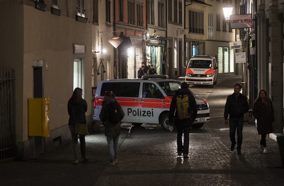 Polizisten kontrollieren jugendliche Menschen am Freitag Abend im Niederdorf, 9. April 2021 in Zuerich. (KEYSTONE/Ennio Leanza)