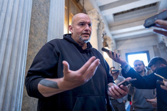Sen. John Fetterman, D-Pa., talks to reporters as the Senate prepares to advance the $95 billion aid package for Ukraine, Israel and Taiwan passed by the House, at the Capitol in Washington, Tuesday,  ...