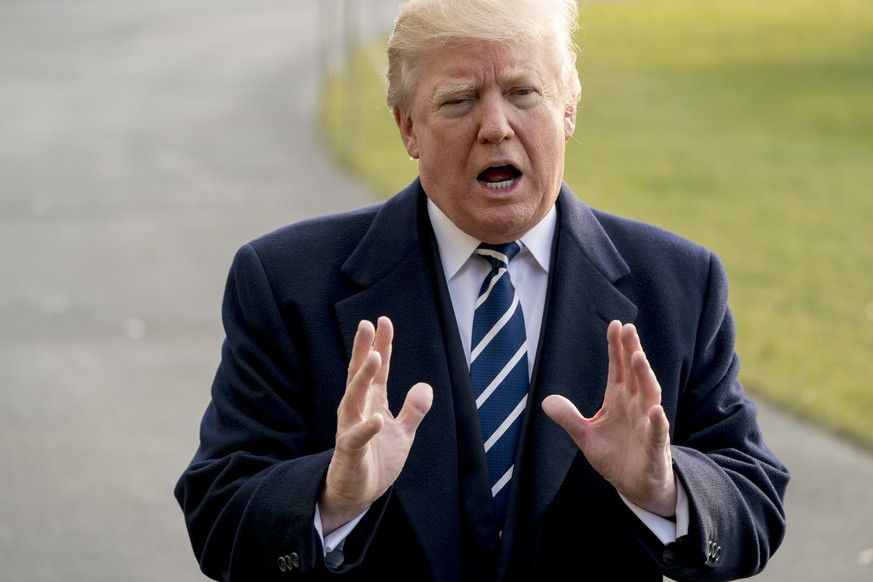 President Donald Trump speaks to members of the media before boarding Marine One at the White House, Saturday, Dec. 2, 2017, in Washington. Trump is traveling to New York for a fundraising event. (AP  ...