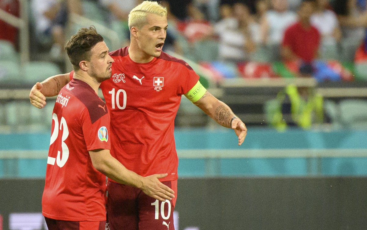 Switzerland's midfielder Xherdan Shaqiri, left, celebrates the second goal with Switzerland's midfielder Granit Xhaka, right, during the Euro 2020 soccer tournament group A match between Swi ...