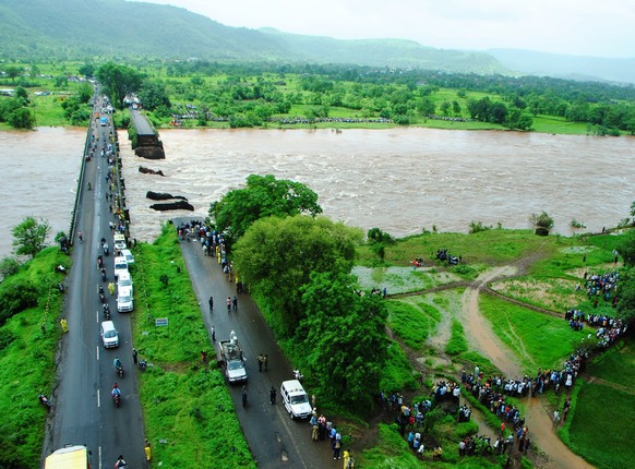 This photo released by the public relations office of Indian Defence shows an old bridge that collapsed in a flooded river in western Maharashtra state, India, Wednesday, Aug. 3, 2016. Two buses plung ...