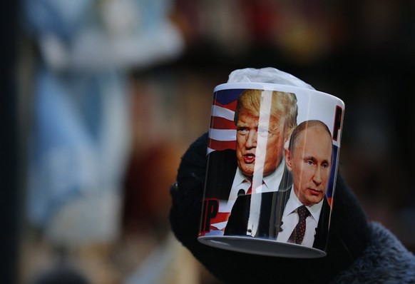 epa05734373 A mug depicting Donald Trump and Russian President Vladimir Putin on sale several hours before Donald J. Trump is sworn in as the 45th President of the United States, at a souvenir street  ...