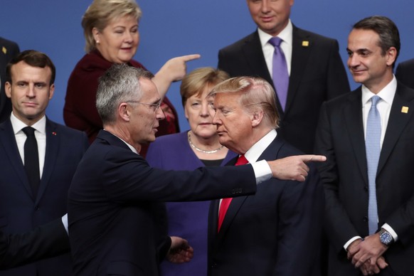 FILE - In this Dec. 4, 2019, file photo, NATO Secretary-General Jens Stoltenberg, front left, speaks with U.S. President Donald Trump, front right, after a group photo at a NATO leaders meeting at The ...