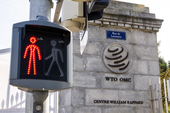 epa12007241 A pedestrian trafic light next to the entrance the World Trade Organization (WTO) headquarters in Geneva, Switzerland, 03 April 2025. EPA/MARTIAL TREZZINI