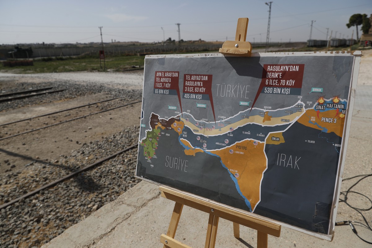 A map showing Turkey's suggested possible operation in Syria, used by a TV journalist is seen at the border between Turkey and Syria, in Akcakale, Sanliurfa province, southeastern Turkey, Tuesday ...