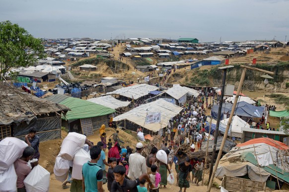 Rohingya Muslims, who crossed over from Myanmar into Bangladesh, walk in a narrow pathway at Kutupalong refugee camp in Ukhiya, Bangladesh, Wednesday, Nov. 15, 2017. Secretary of State Rex Tillerson s ...