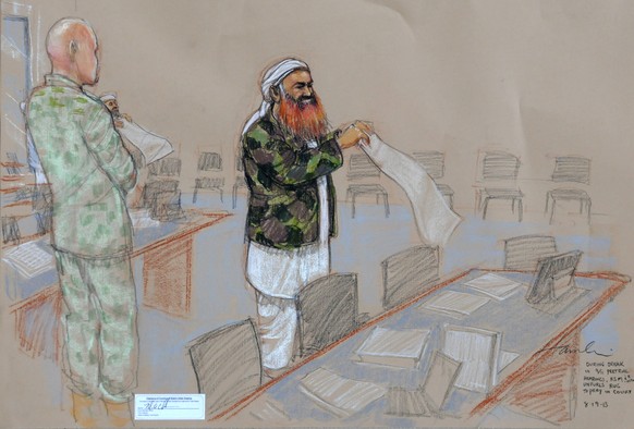 FILE - This Aug. 19, 2013 file photo of a sketch by courtroom artist Janet Hamlin, reviewed by the U.S. Department of Defense, shows self-proclaimed terrorist mastermind Khalid Sheikh Mohammed unfurli ...