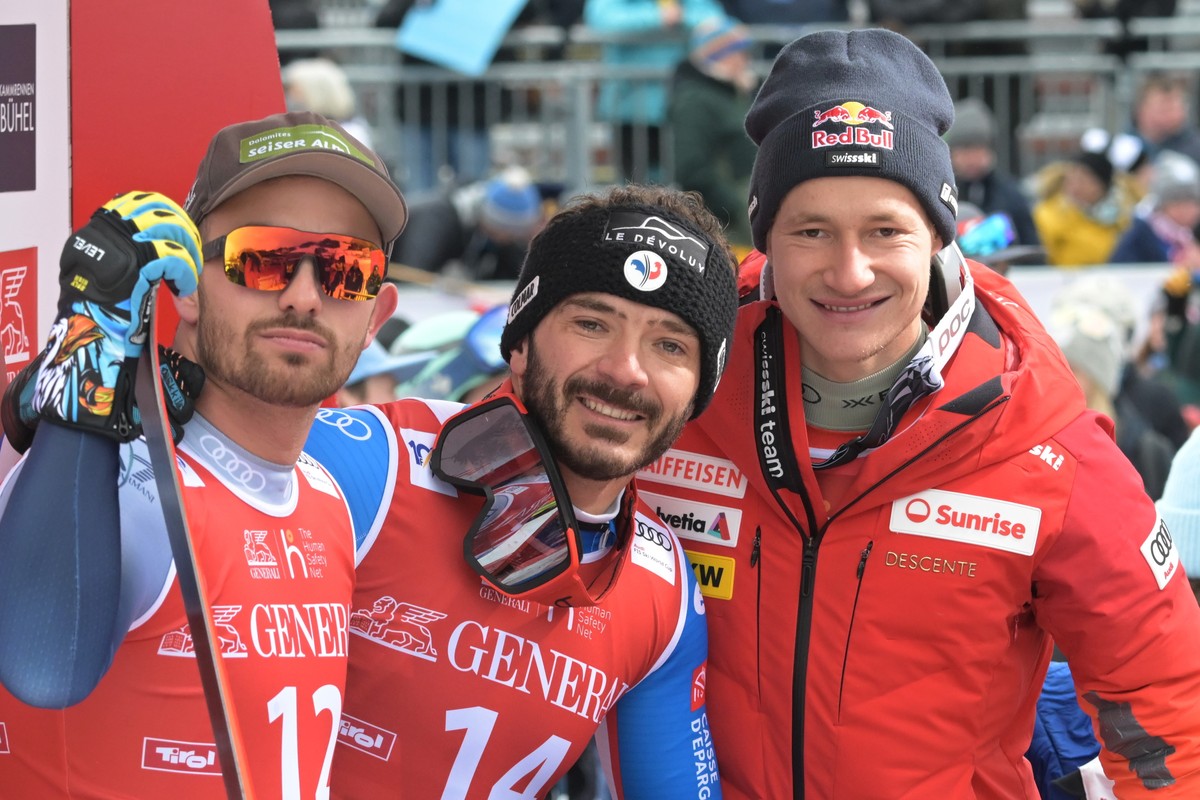 epa11089601 (L-R) Florian Schieder of Italy, Cyprien Sarrazin of France and Marco Odermatt of Switzerland pose in the finish area during the Men's Downhill race at the FIS Alpine Skiing World Cup ...