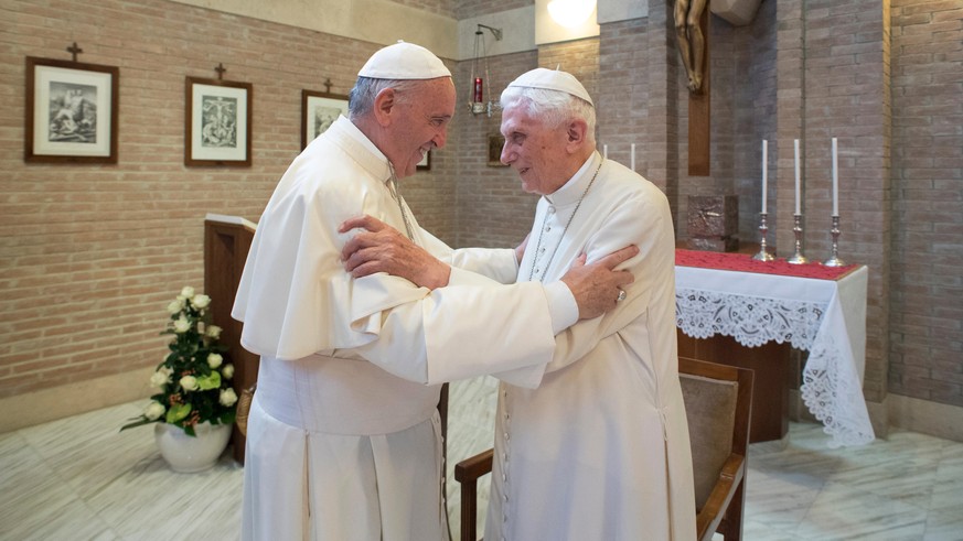 FILE - Pope Francis embraces Pope Emeritus Benedict XVI, right, at the Vatican, on June 28, 2017. Pope Benedict XVI&#039;s 2013 resignation sparked calls for rules and regulations for future retired p ...