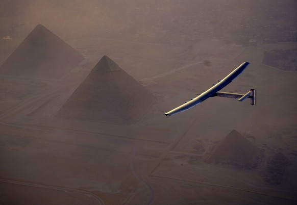 In this Wednesday, July 13, 2016, handout image provided by Solar Impulse, the Solar Impulse 2 flying over the pyramids, Egypt Cairo. The experimental solar-powered airplane has arrived in Egypt as pa ...