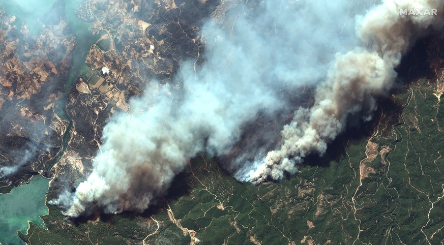 epa09381777 A handout satellite image made available by Maxar Technologies shows wildfires burning near the Oymapinar dam, southern Turkey, 29 July 2021 (issued 31 July 2021). According to a statement ...