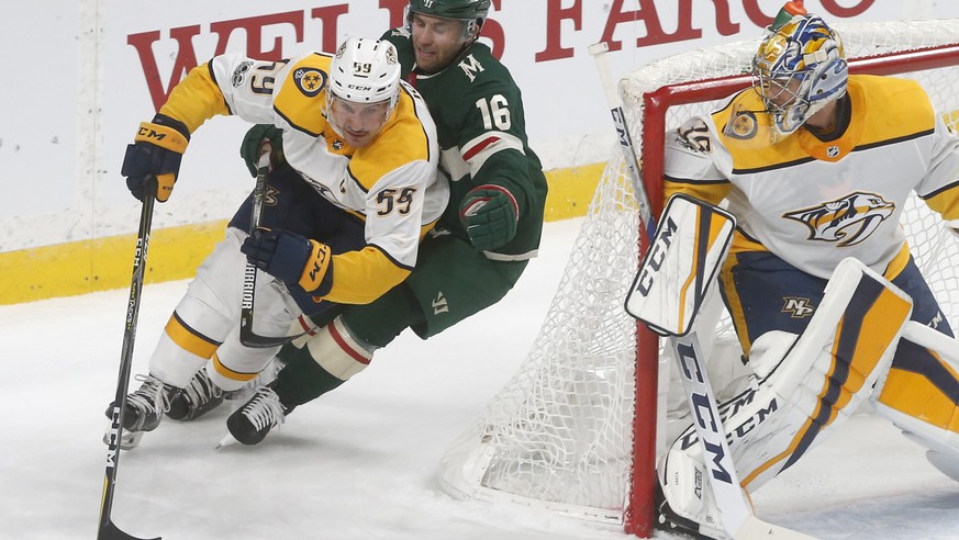 Minnesota Wild&#039;s Jason Zucker, center, pursues Nashville Predators&#039; Roman Josi of Switzerland for the puck as Nashville Predators goalie Pekka Rinne, right, of Finland looks on in the first  ...