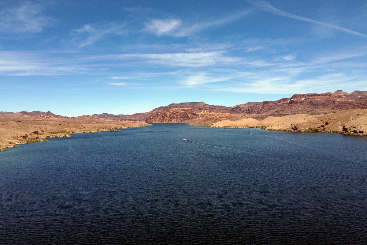 epa10586900 A photo taken with a drone shows the Colorado River flowing south of the Hoover Dam near Boulder, Nevada, USA, 22 April 2023. Lake Mead water level is set to rise 33 feet higher than expec ...
