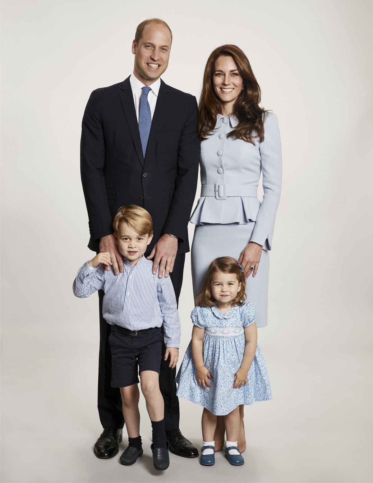 In this undated photo provided by Kensington Palace on Monday, Dec. 18, 2017, Britain's Prince William, background left and Kate, the Duchess of Cambridge pose with their children Prince George a ...
