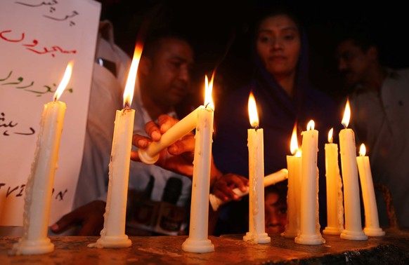 epa07520425 People light candles as they condemn the deadly bomb blasts in Sri Lanka, during a protest in Karachi, Pakistan, 21 April 2019. According to police at least 207 people were killed and more ...