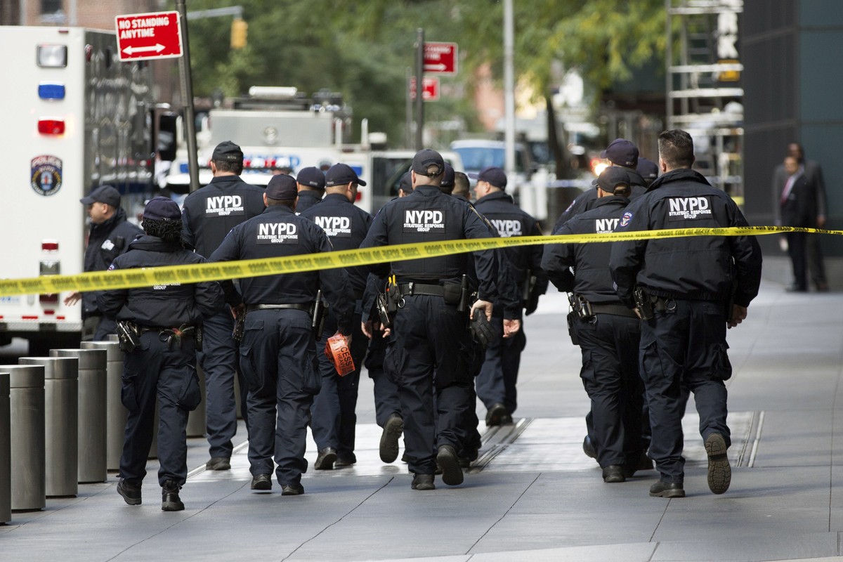 NYPD officers depart from the Time Warner Center area on Wednesday, Oct. 24, 2018, in New York. Law enforcement officials say a suspicious package that prompted an evacuation of CNN's offices is  ...