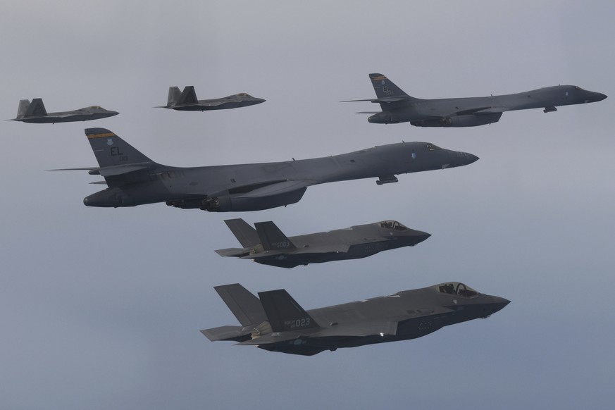 FILE - In this photo, provided by the South Korean Department of Defense, U.S. Air Force B-1B bombers fly, centered, South Korean Air Force F-22 fighter jets and F-35 fighter jets, below , flying over South Korean Penins...