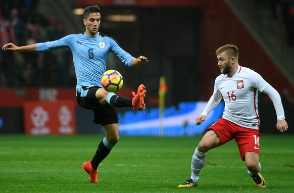 epa06321210 Jakub Blaszczykowski (R) of Poland in action against Rodrigo Bentancur (L) of Uruguay during the international friendly soccer match between Poland and Uruguay at the PGE National Stadium  ...