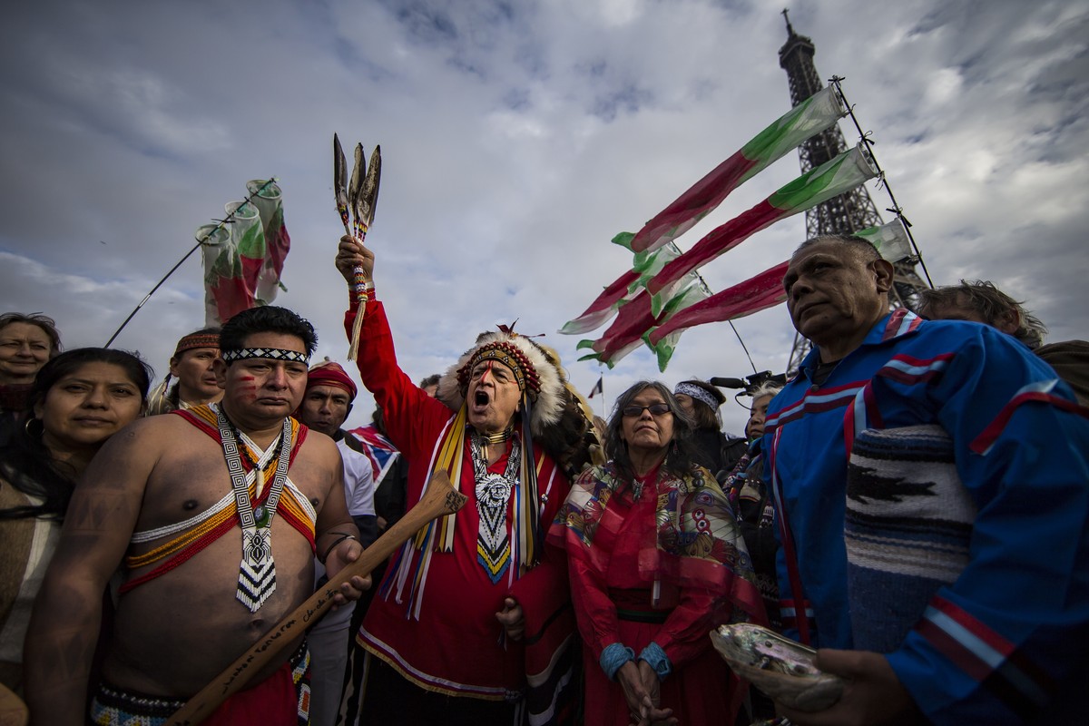 epa12507174 (FILE) - Indigenous representatives from around the world engage in a joint prayer session on board of a river boat on the Seine river, as part of a campaign to draw attention to the pligh ...